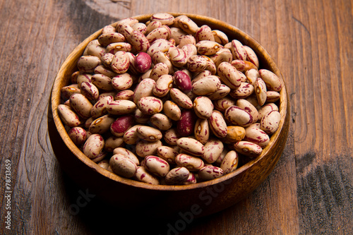 pinto beans on wood bowl