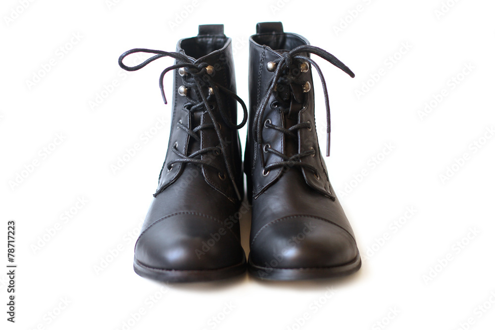 Pair of black boots on white background