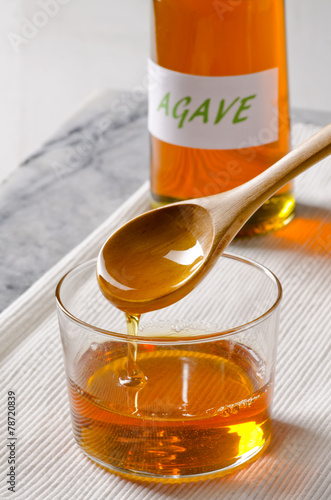 Agave syrup pouring on a glass.