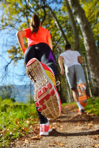 Young couple jogging in the park at morning. Health and fitness.