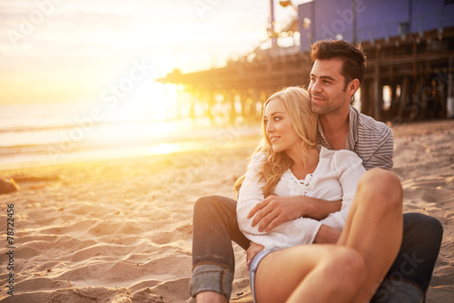romantic couple having fun at santa monica on beach photo