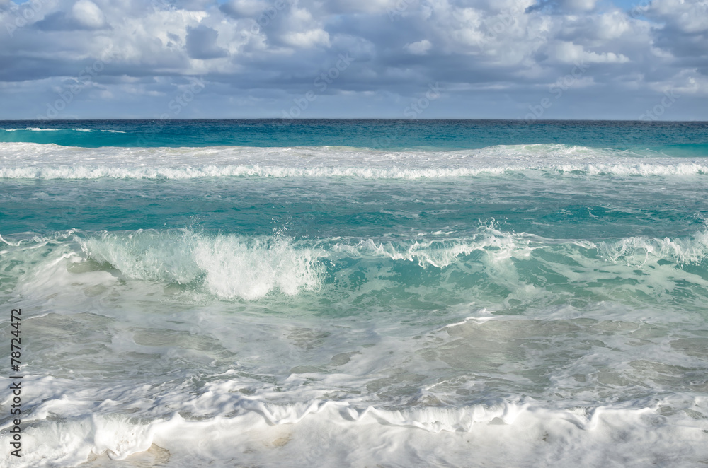 White foamy waves and gradually darkening color of sea water