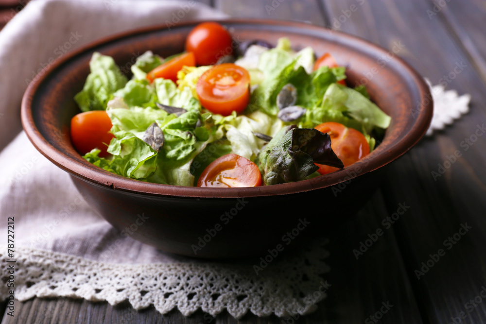 Salad with arugula and cherry tomatoes on wooden table Salad with arugula and cherry tomatoes on wooden table
