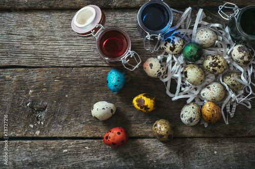 Colorful Easter eggs on wooden background with blank space
