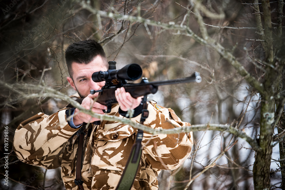 Hunting, army, military - sniper holding rifle and aiming