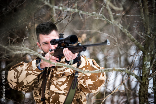 Hunting, army, military - sniper holding rifle and aiming