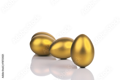 Golden eggs isolated on white background