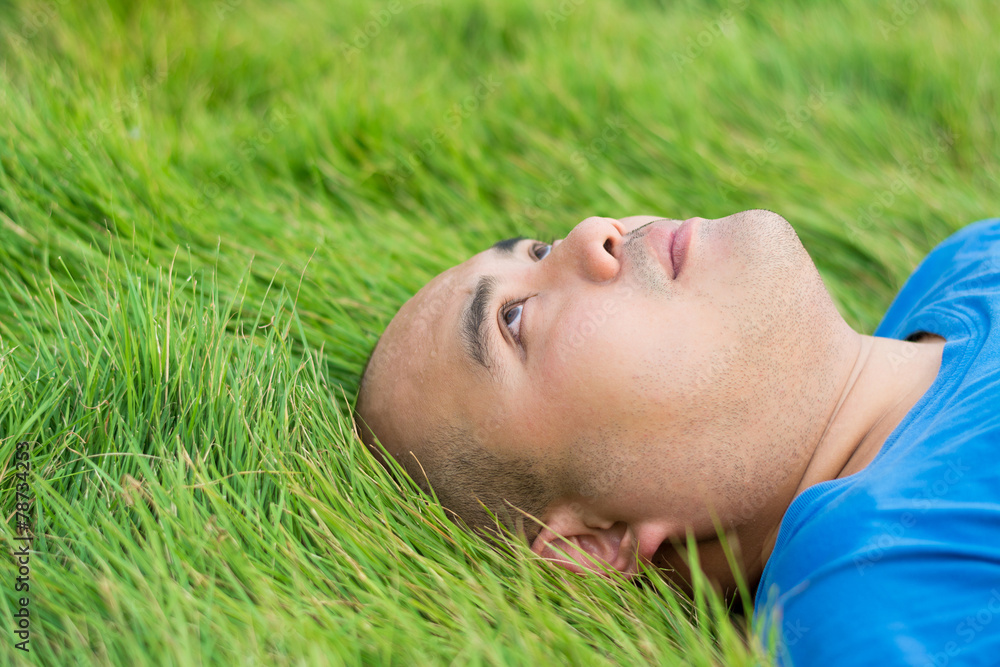 Fat Man Lying on the Green Grass with a stress thoughts in mind Fat Man Lying on the Green Grass with a stress thoughts in mind