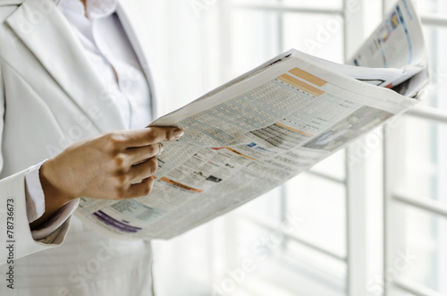 Closeup woman hand holding newspaper
