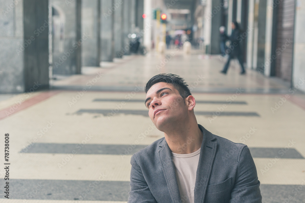 Young handsome man posing in the city streets Young handsome man posing in the city streets
