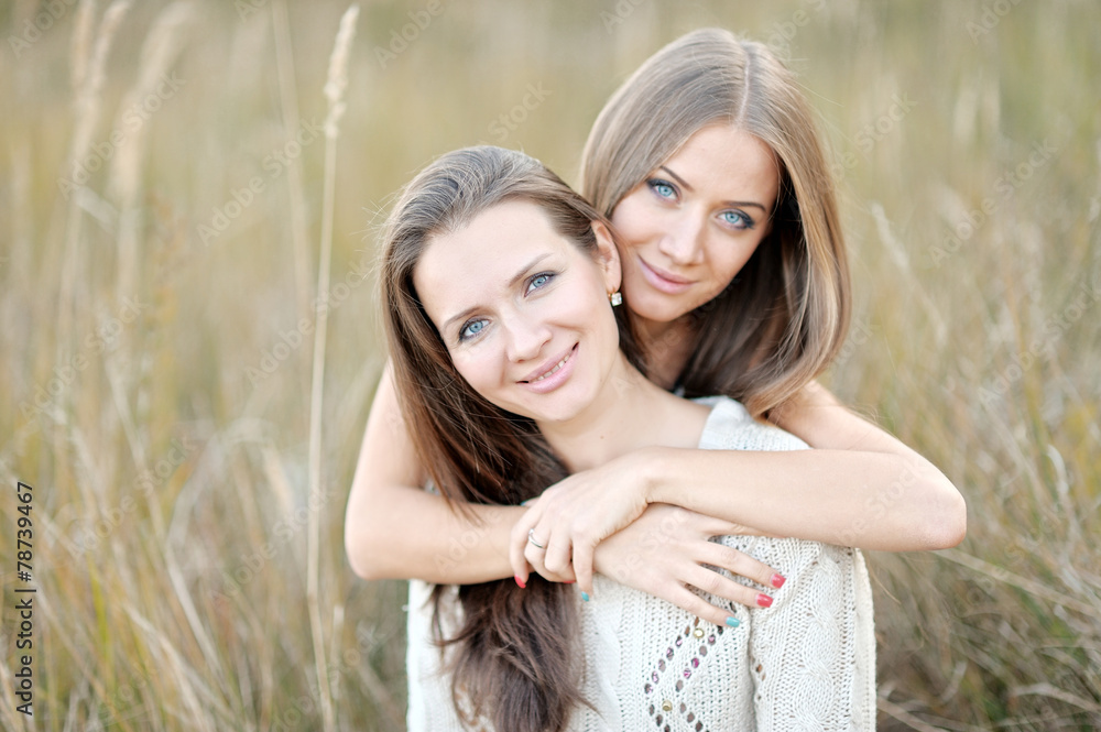 Fototapeta premium portrait of two beautiful sisters in the autumn