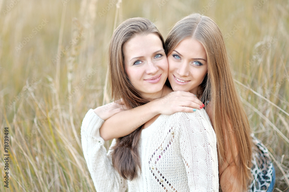 Obraz premium portrait of two beautiful sisters in the autumn