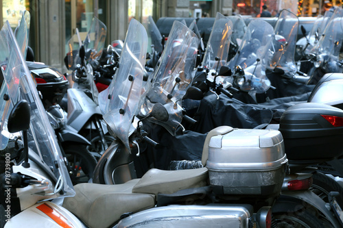 Bild auf Leinwand scooters and mopeds with winter windshield parked in the city