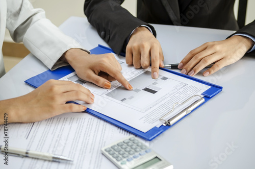 Office worker discussing on printout