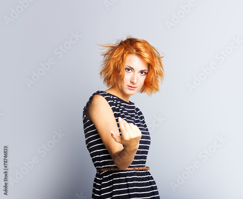 Surprised young girl in stylish dress.