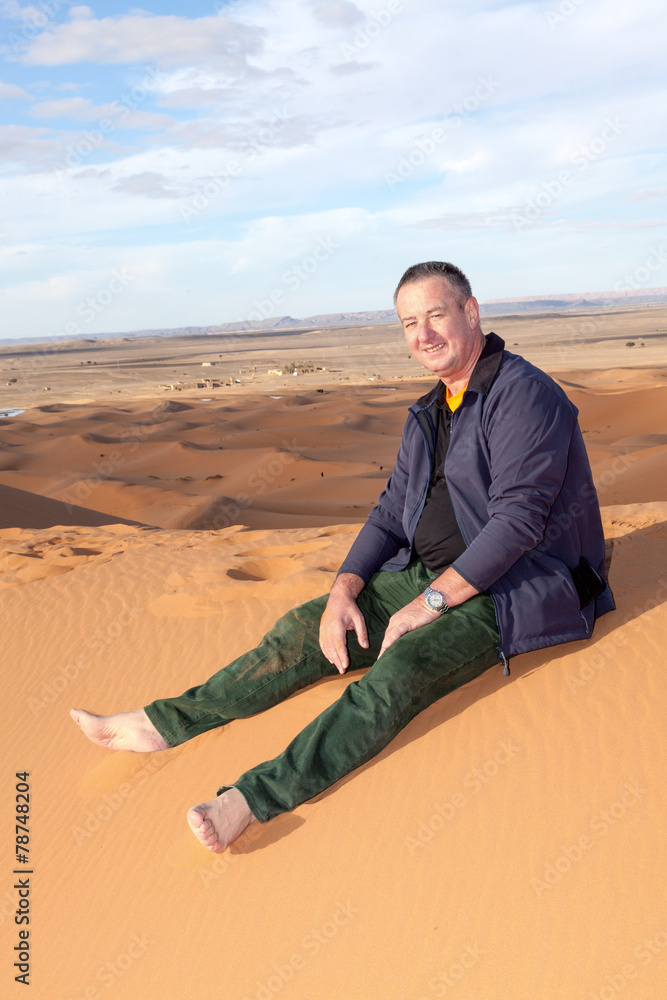 Man alone in the desert on the sand dune Man alone in the desert on the sand dune