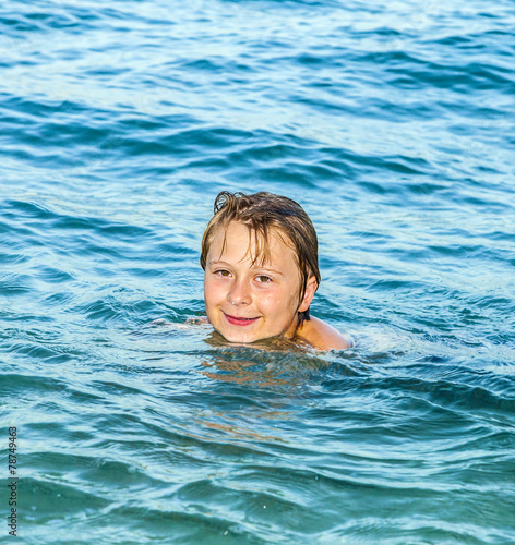Wallpaper Mural boy enjoys the beautiful water of the ocean Torontodigital.ca