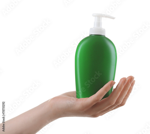 Female hand with cosmetics bottle isolated on white