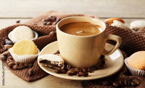 Gentle colorful macaroons and coffee in mug