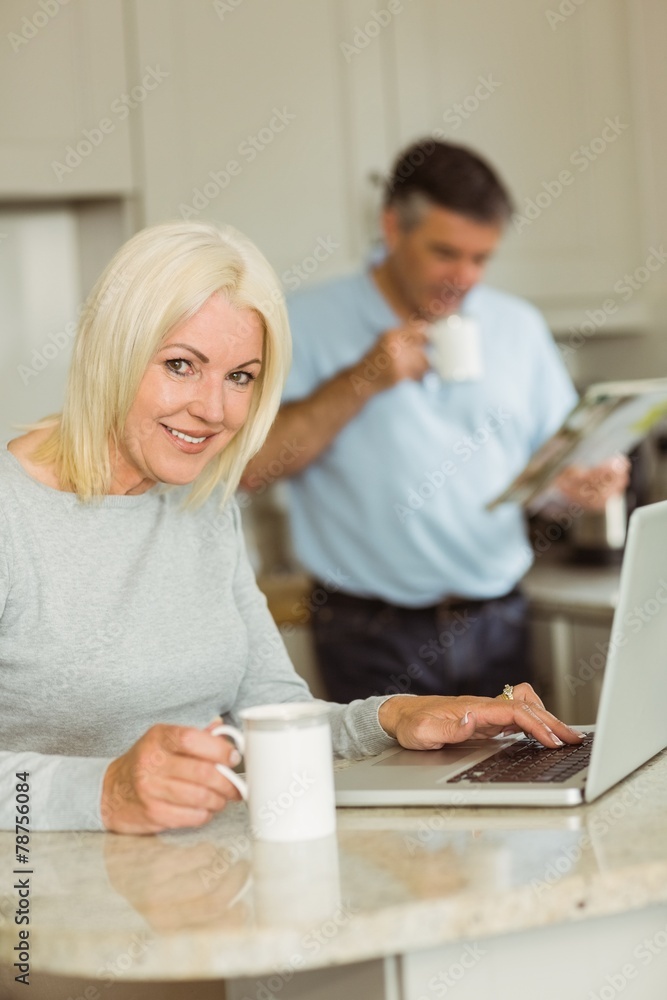 Happy mature blonde using laptop Happy mature blonde using laptop