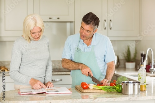 Happy mature couple following a vegetarian recipe