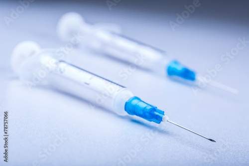 Close-up of plastic syringe on white background. Monochrome tone