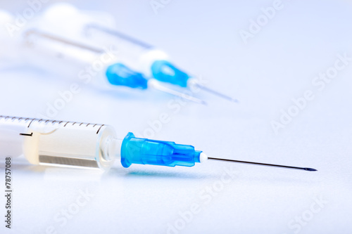 Close-up of plastic syringe on white background. Monochrome tone