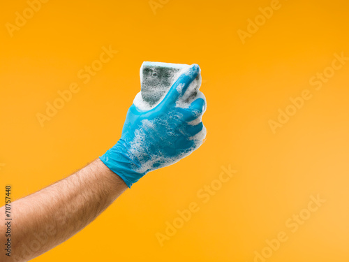 hand holding sponge with detergent