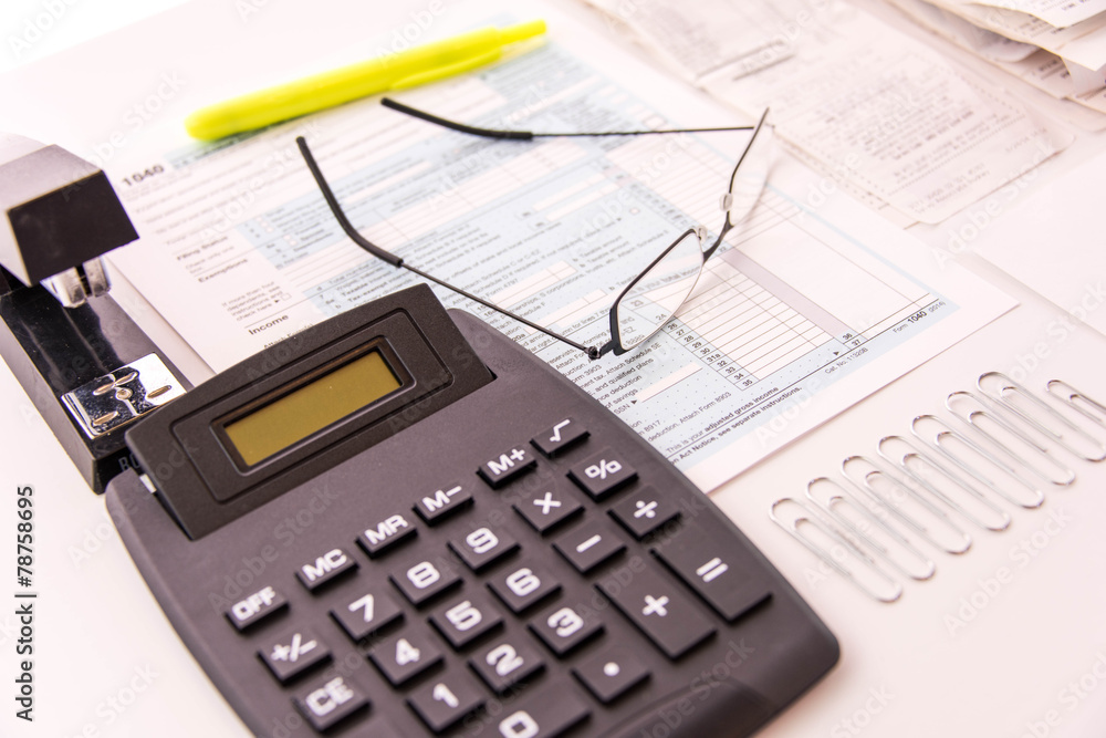 Tax preparation supplies, reading glasses and tax forms Tax preparation supplies, reading glasses and tax forms