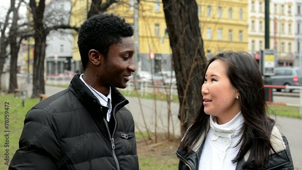 Happy couple talk (conversation) - black man and asian woman Happy couple talk (conversation) - black man and asian woman