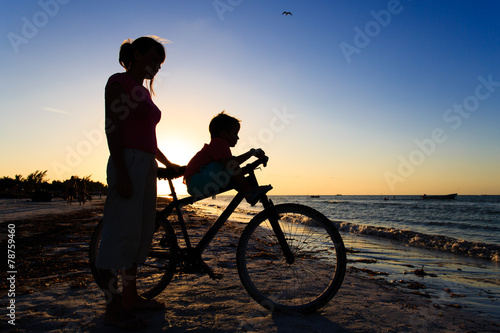 Silhouette of mother and son biking at sunset © nadezhda1906