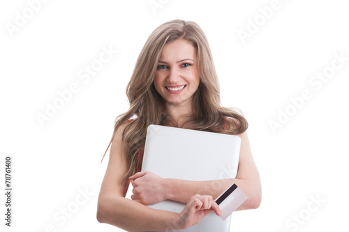 Beautiful young woman holding card and laptop