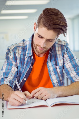 Student taking notes in class