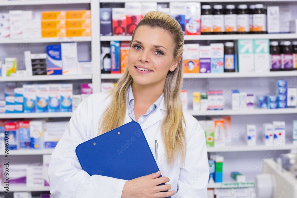 Smiling pharmacist holding clipboard