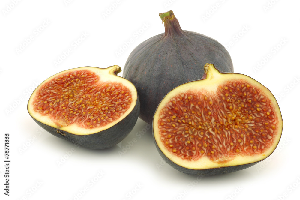 whole and a cut fig (Ficus carica) on a white background
