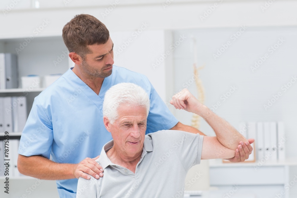 Fototapeta premium Physiotherapist giving physical therapy to man