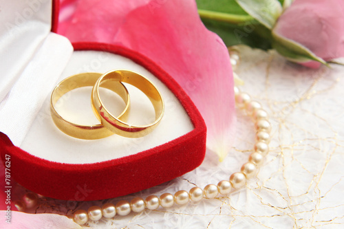 pair of wedding rings with roses for background image photo