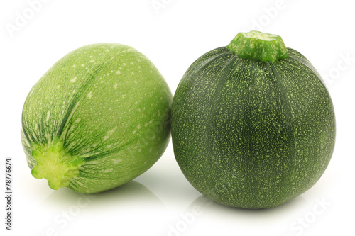 one light green and a green round zucchini cut zucchini