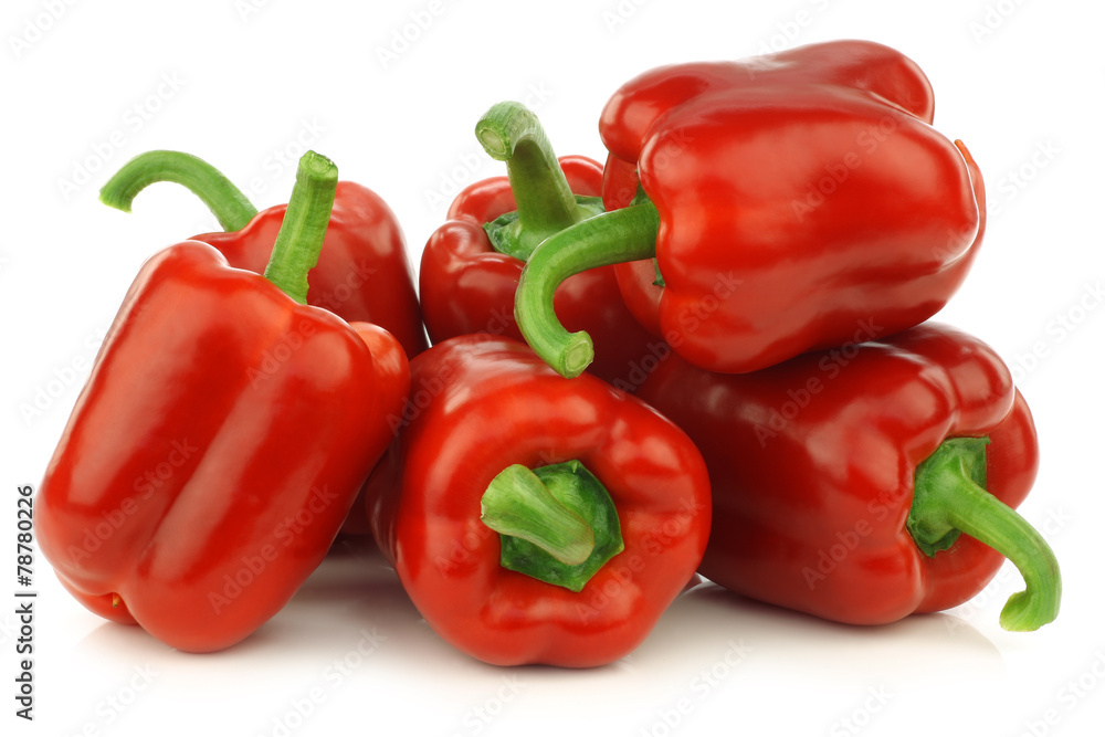 fresh red bell peppers (capsicum) on a white background