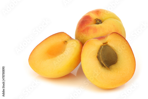 fresh colorful apricot and a cut one on a white background
