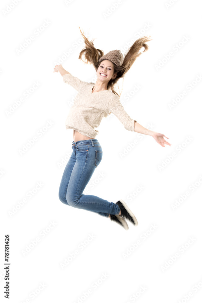 Beautiful teenage girl jumping high with delight
