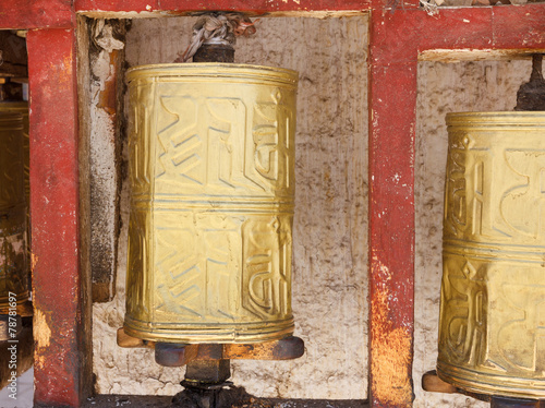 Gold colored Buddhist prayer wheel in Lhasa, Tibet photo