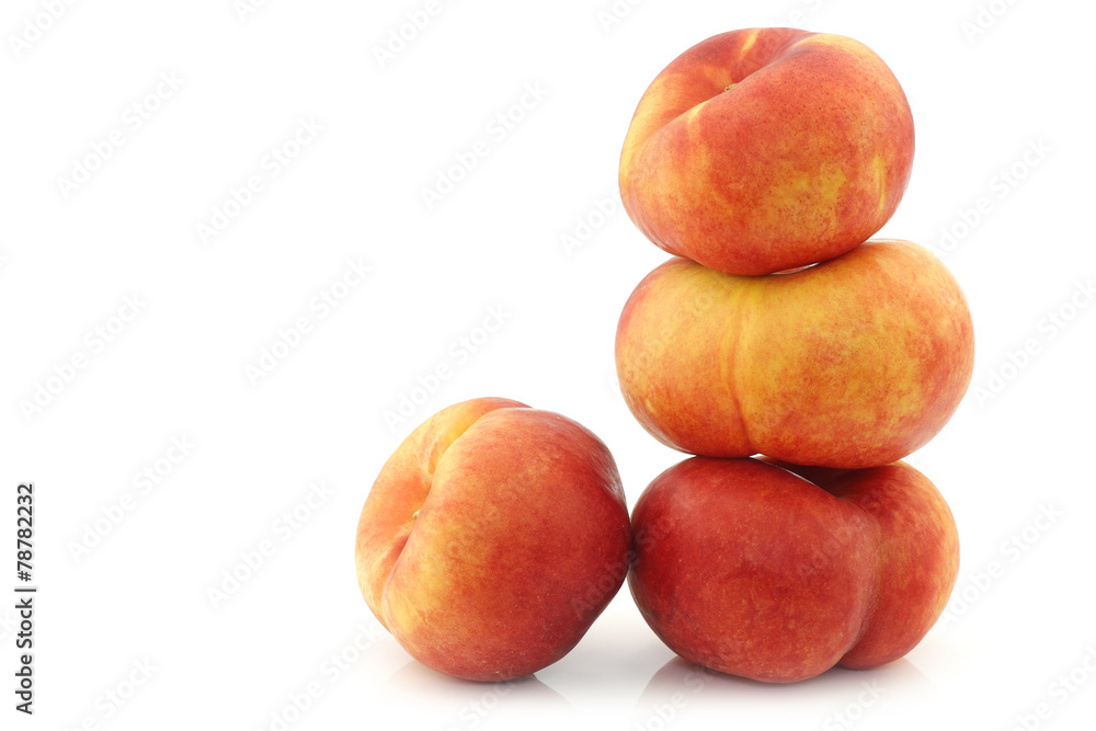 Fresh wild (flat) stacked nectarines on a white background Fresh wild (flat) stacked nectarines on a white background