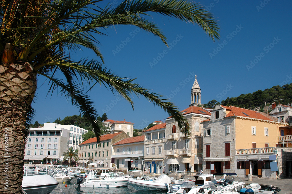 Island Hvar and its harbor with tourist boats