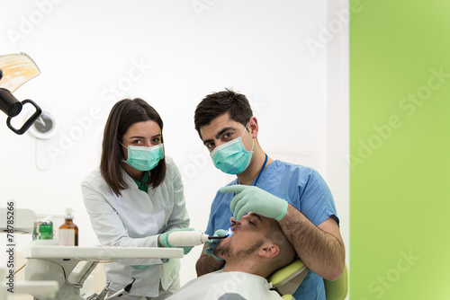Dentist Doing A Dental Treatment On Patient