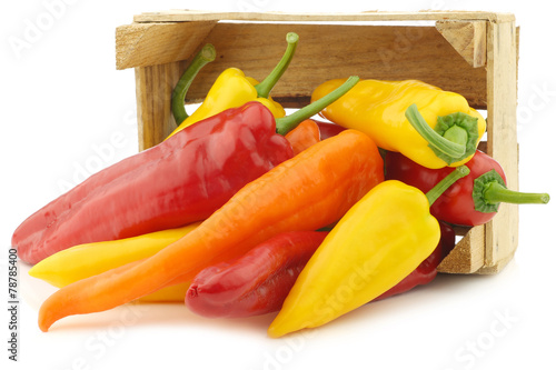 Tela Red,yellow and orange sweet peppers (capsicum) in a wooden crate