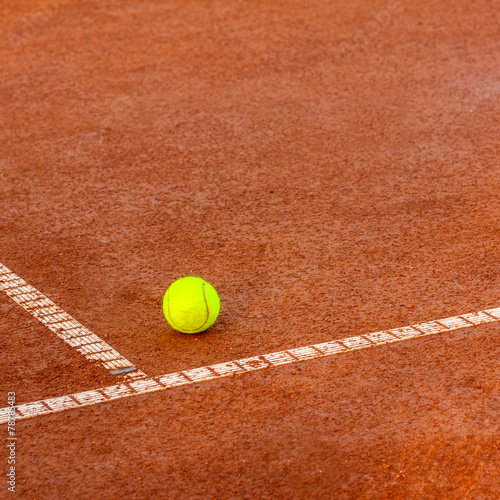 Tennis ball on a tennis court © Kavita