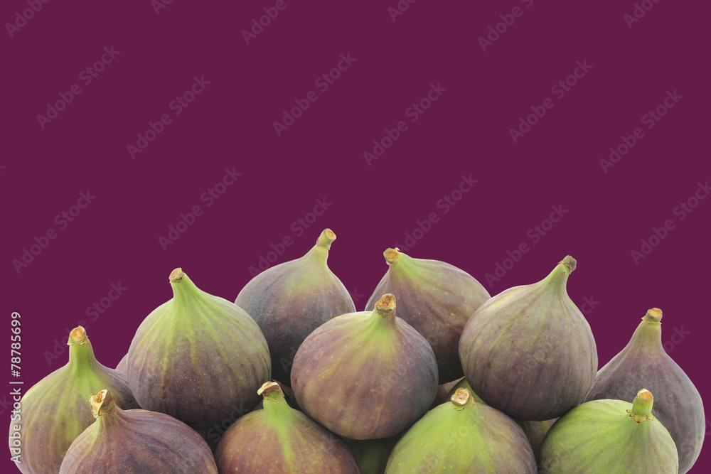 Fototapeta premium fresh figs (Ficus carica) on a purple background with copy space