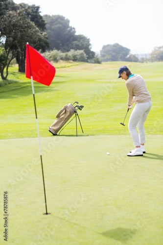 Female golfer putting her ball
