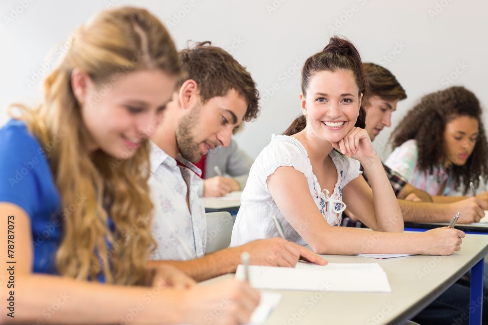 Fototapeta premium Students writing notes in classroom